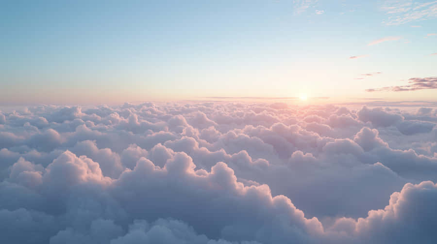 Dreamy Sunrise Over A Sea Of Soft, Fluffy Clouds In The Sky Wallpaper