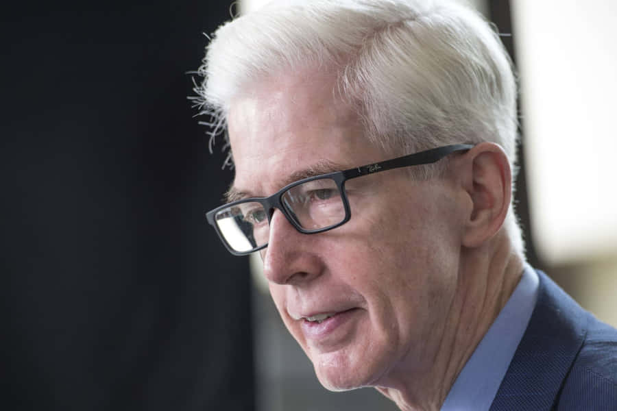 Elderly Manin Glassesand Suit Wallpaper