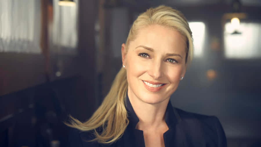 Elegant Blonde Woman Smiling Wallpaper