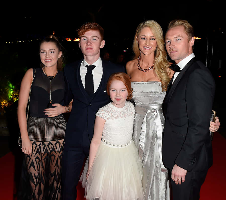 Elegant Family Red Carpet Appearance Wallpaper