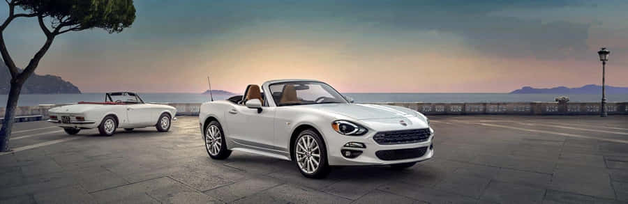 Elegant Fiat 124 Spider On The Open Road Wallpaper