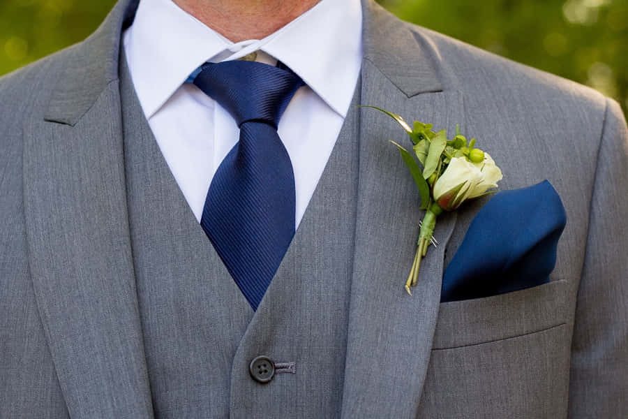 Elegant Groom Navy Blue Tieand Boutonniere Wallpaper