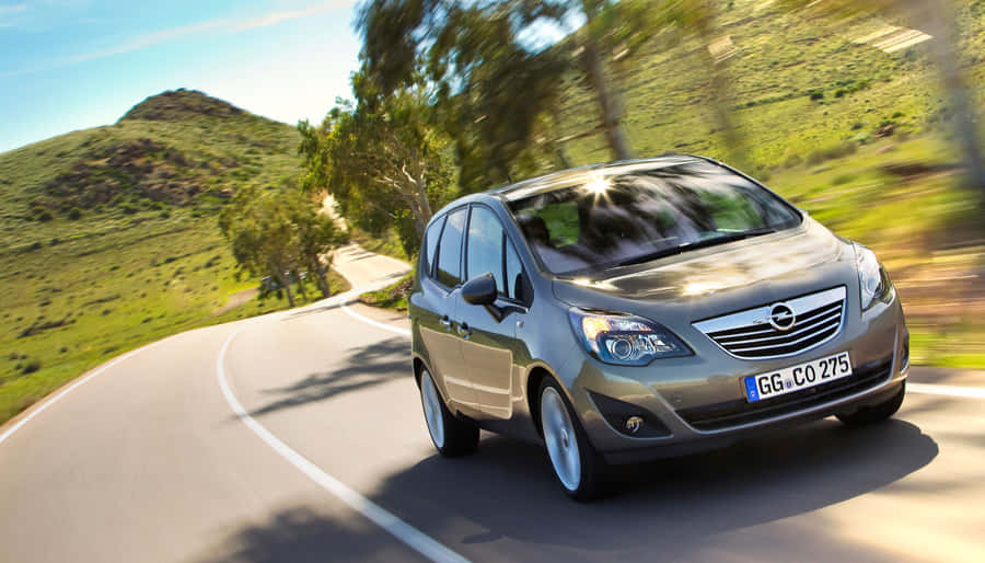 Elegant Opel Meriva In Motion On A Bright Day Wallpaper