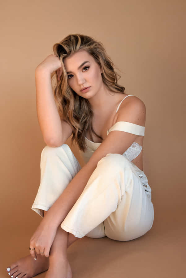 Elegant Portraitof Womanin Cream Outfit Wallpaper