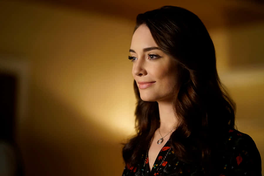 Elegant Smiling Woman Golden Backdrop Wallpaper