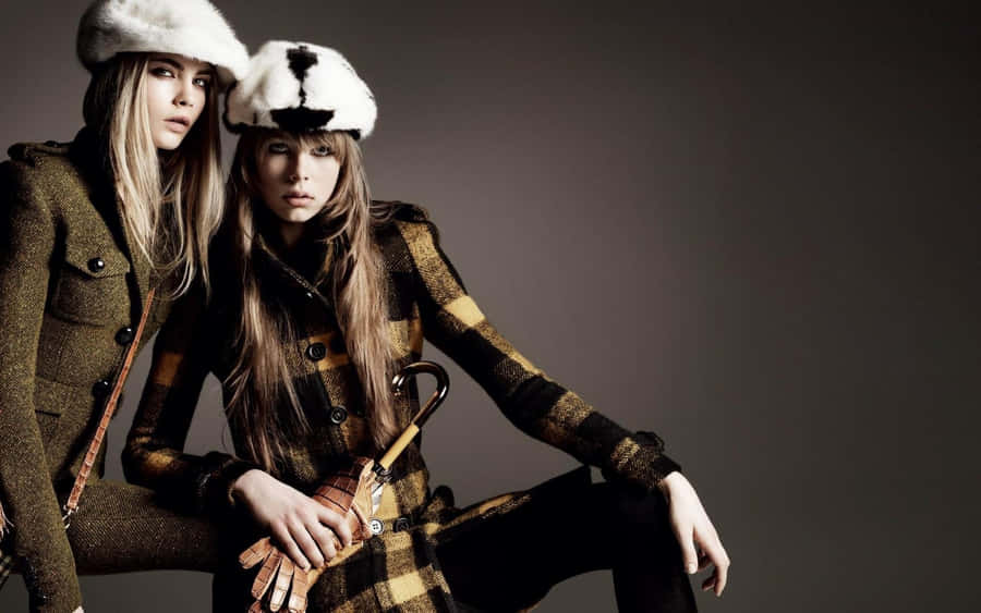 Elegant Winter Attire In Snowy Cityscape Wallpaper