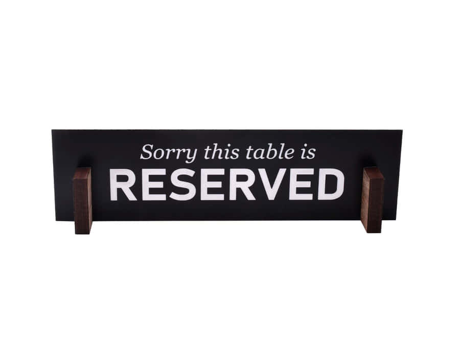 Elegant Wooden Reserved Sign On A Restaurant Table Wallpaper
