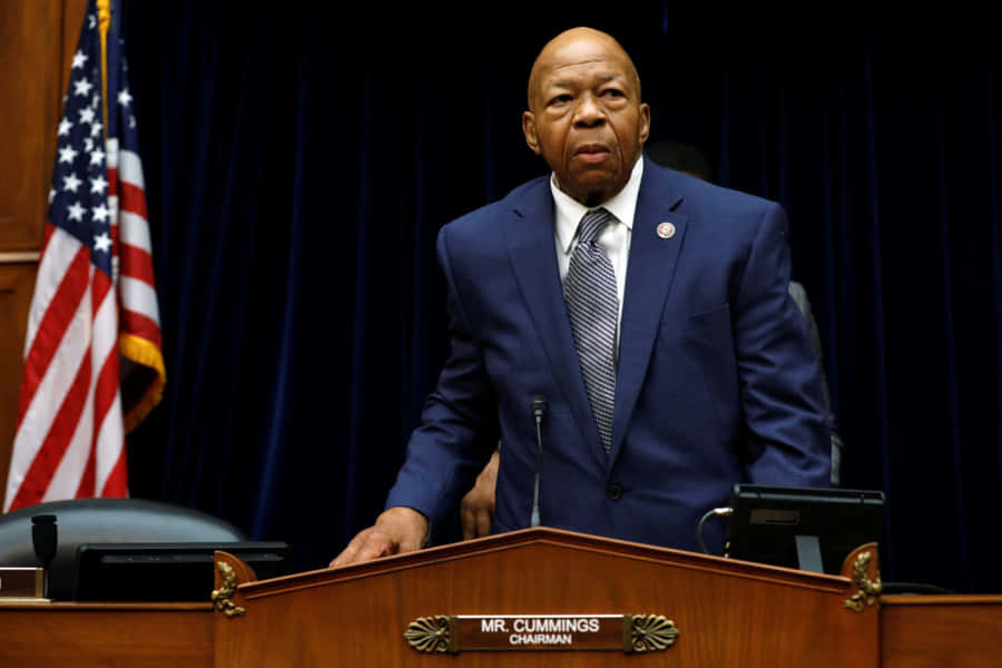 Elijah Cummings With American Flag And Black Backdrop Wallpaper