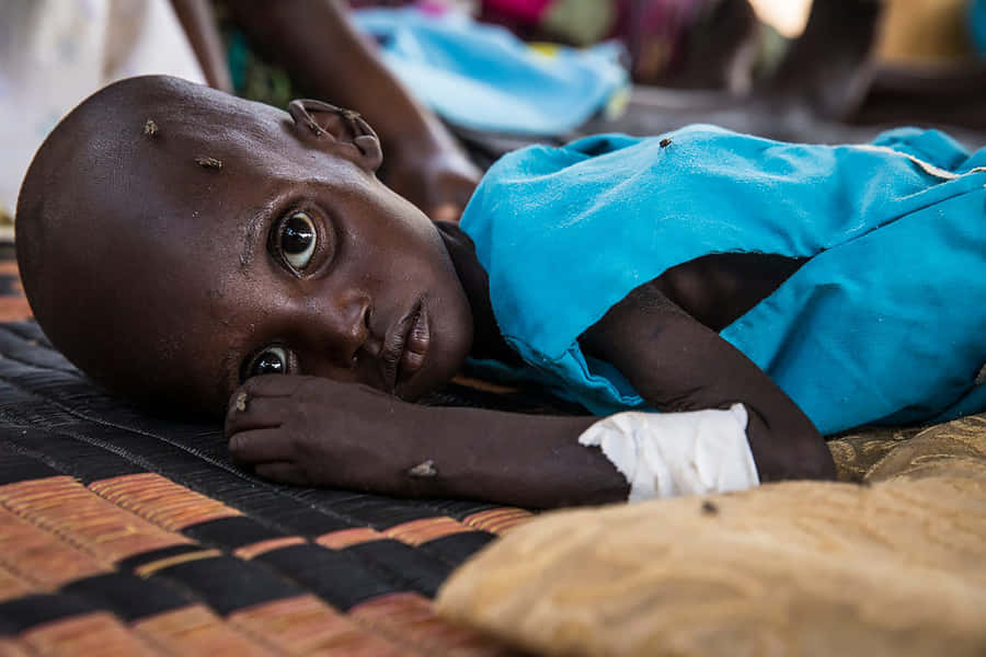Emaciated Child With Big Eyes Wallpaper