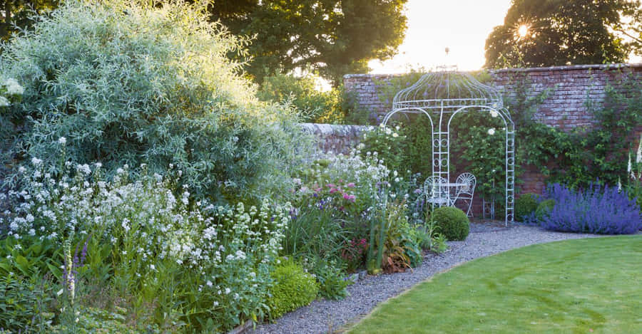 Enchanting Cottage Garden In Full Bloom Wallpaper