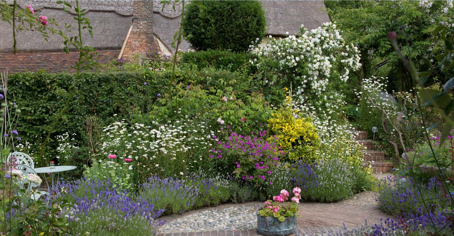 Enchanting Cottage Garden In Full Bloom Wallpaper