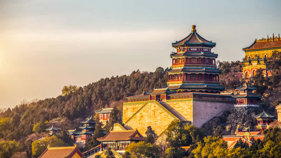 Enchanting Summer Palace Surrounded By Lush Green Trees Wallpaper