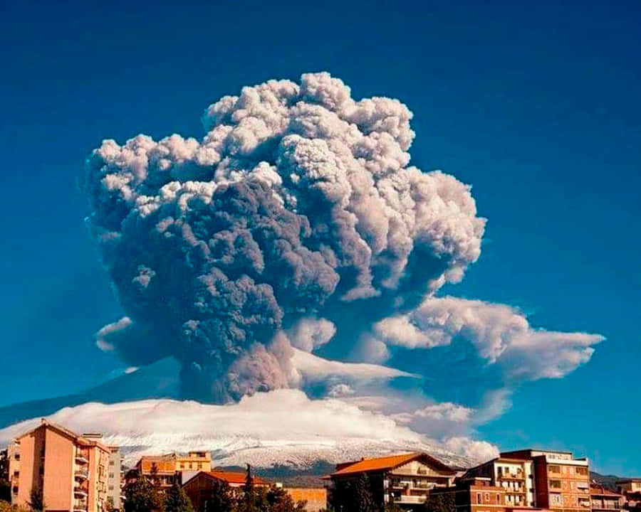 Enchanting View Of Sicilian Village With Mount Etna In Background Wallpaper