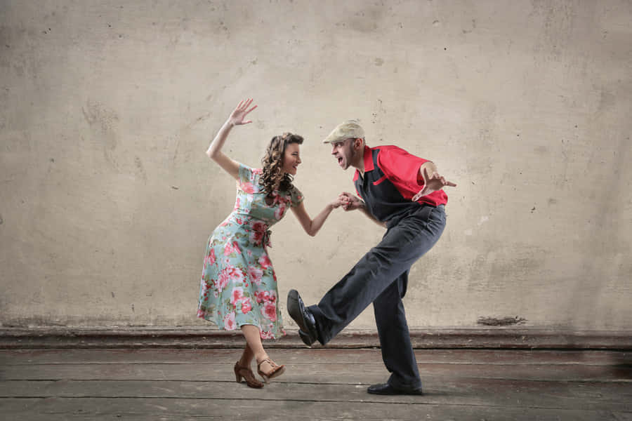 Energetic Swing Dancers Showcasing Classic Moves Wallpaper