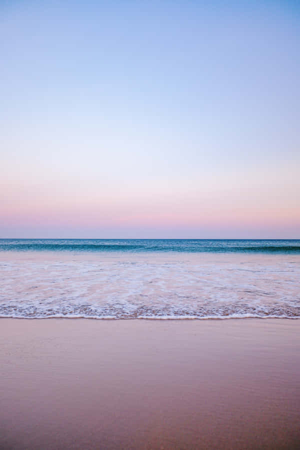 Enjoy A Blissful Day Of Rest And Relaxation At The Tranquil Pastel Beach. Wallpaper