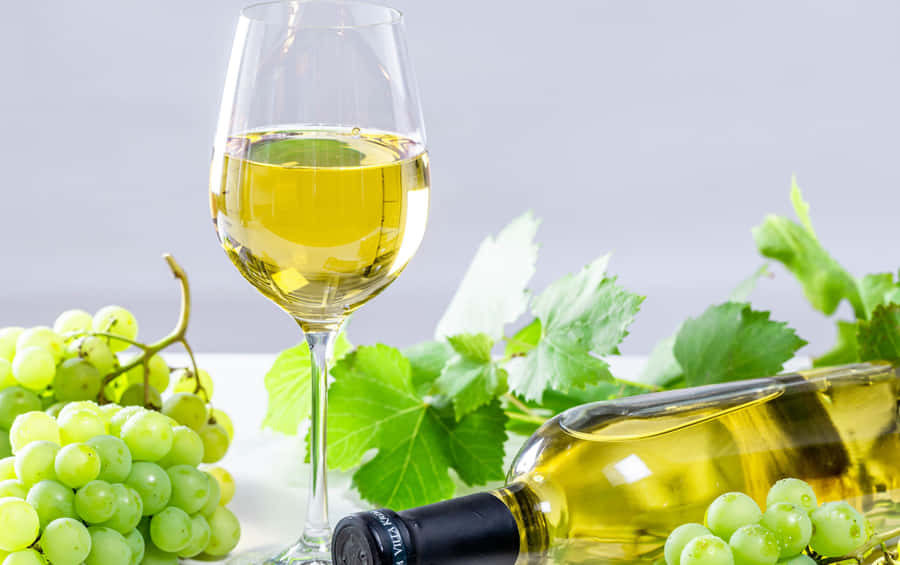 Enjoy A Chilled Glass Of White Wine In The Warm Summer Sun. Wallpaper