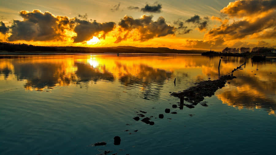 Enjoy A Cool Sunset In Nature's Glory Wallpaper