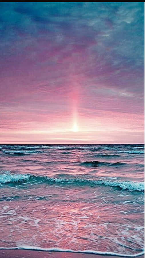Enjoy A Peaceful Day At The Beach With A Pink Beach Aesthetic Wallpaper