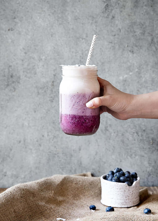 Enjoy The Delicious Taste Of Blueberry Smoothie On A Warm Summer Day. Wallpaper