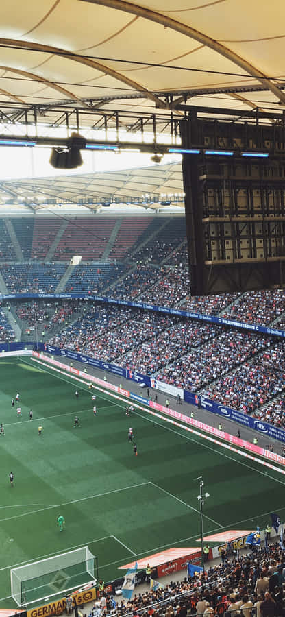 Enjoy The Electrifying Atmosphere Of The Soccer Stadium Wallpaper