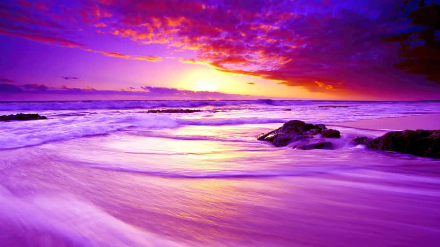 Enjoy The Shades Of Sunset On A Warm Beach Wallpaper