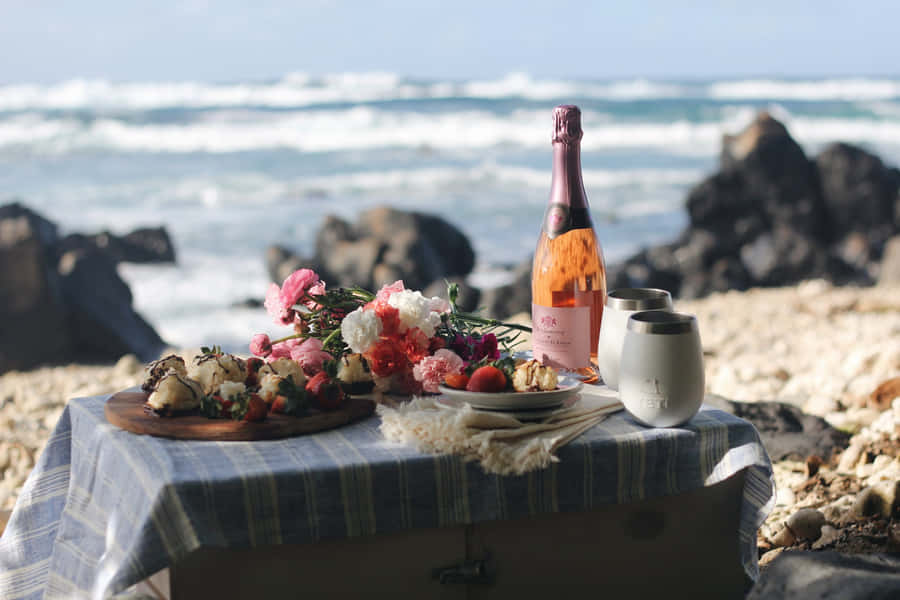 Enjoying A Relaxing Beach Picnic On A Sunny Day Wallpaper