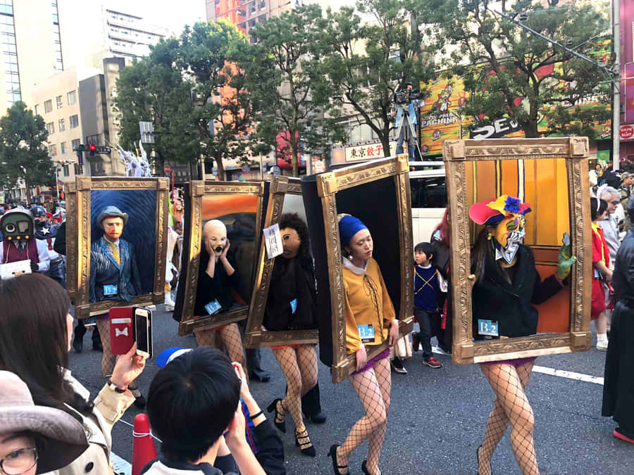 Enjoying The Festivities At A Halloween Parade Wallpaper