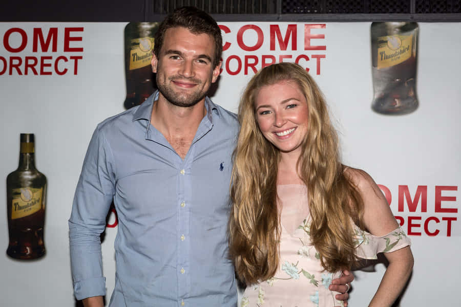 Event Attendees Smilingat Camera Wallpaper