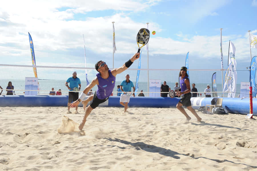 Exciting Beach Tennis Action Wallpaper