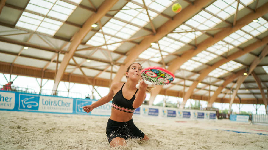Exciting Beach Tennis Action Wallpaper