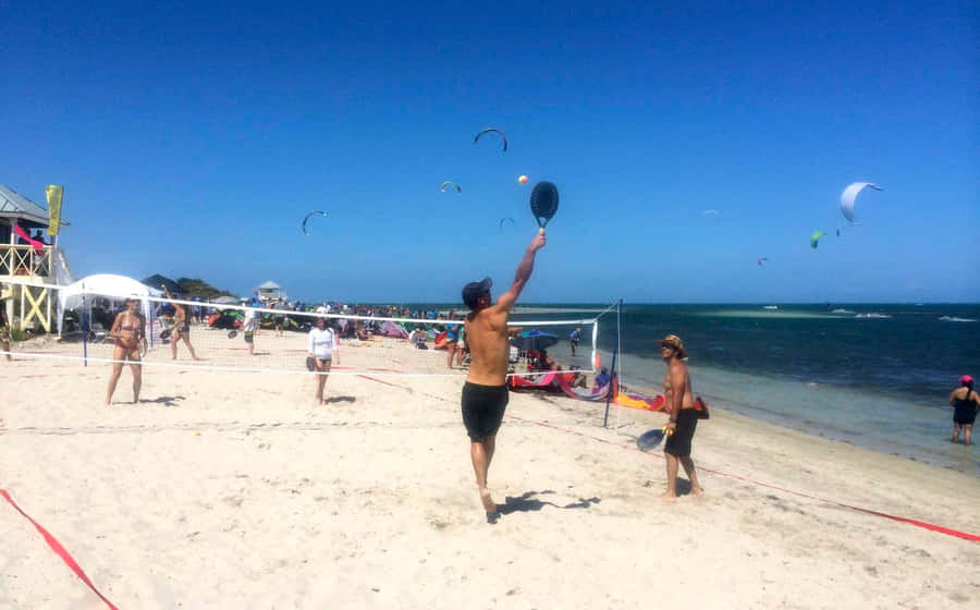 Exciting Beach Tennis Doubles Match Wallpaper