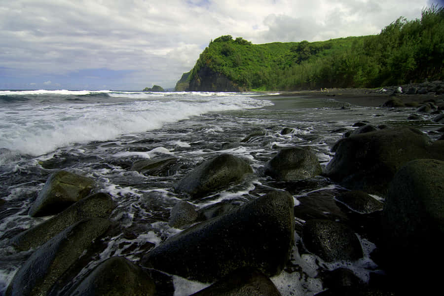 Experience The Peaceful Beauty Of A Black Sand Beach Wallpaper