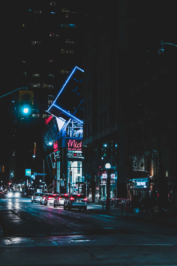 Explore The Bright Lights And Energy Of A Neon-lit City. Wallpaper