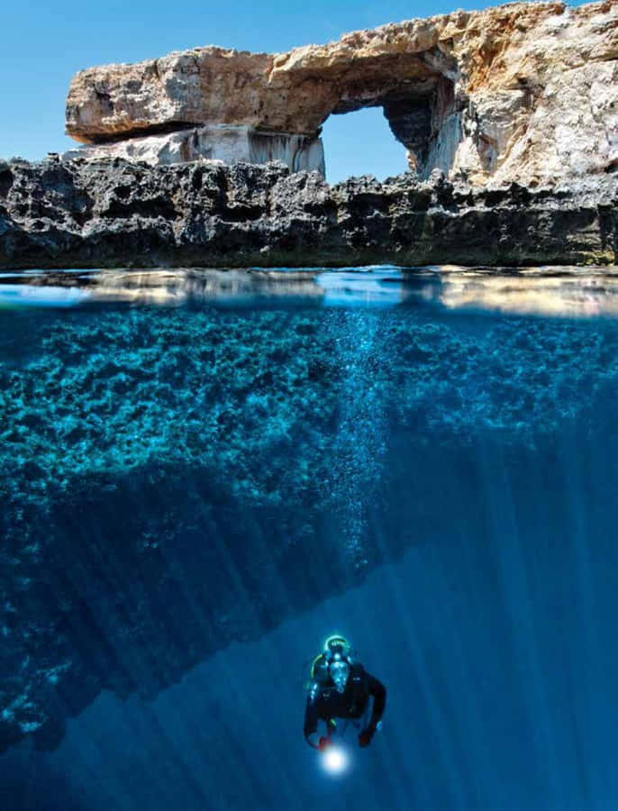 Exploring The Mysterious Depths Of A Blue Hole Wallpaper