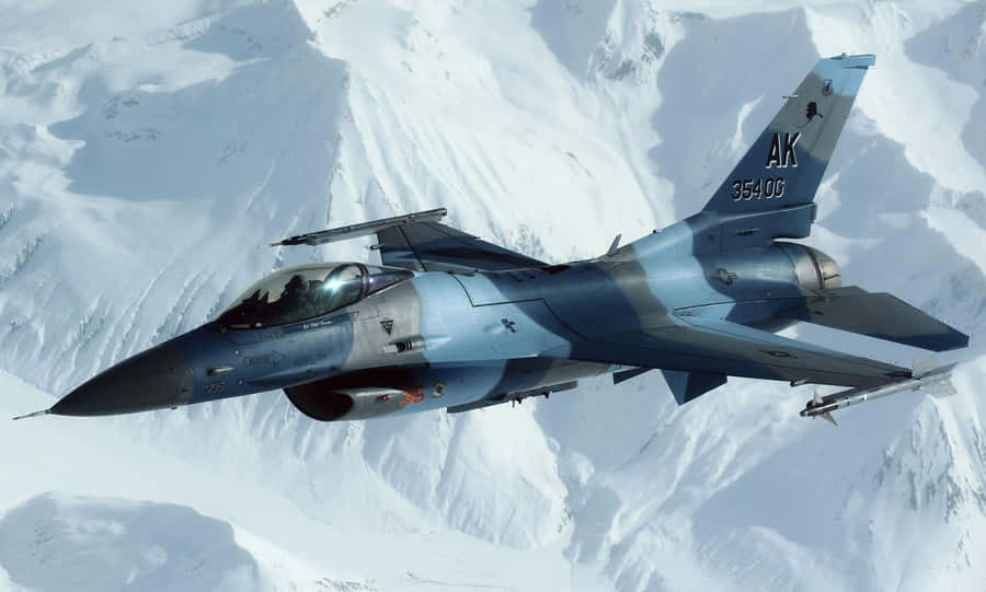 F16 Fighting Falcon Over Snowy Mountains Wallpaper