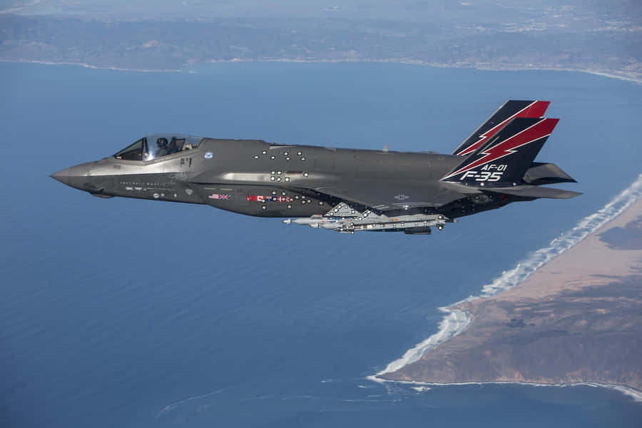 F35 Jet In Flight Over Coastline Wallpaper