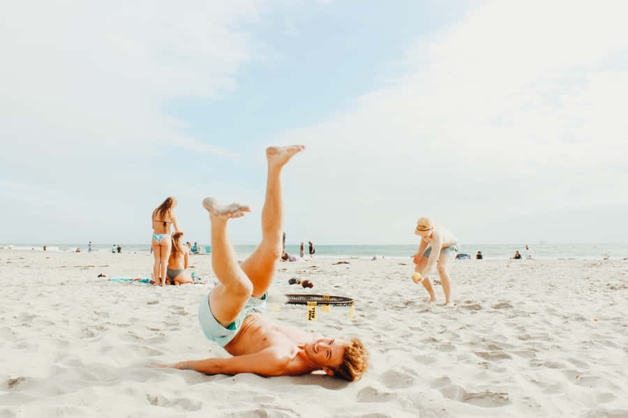Family Having Fun At The Beach During Summer Vacation Wallpaper