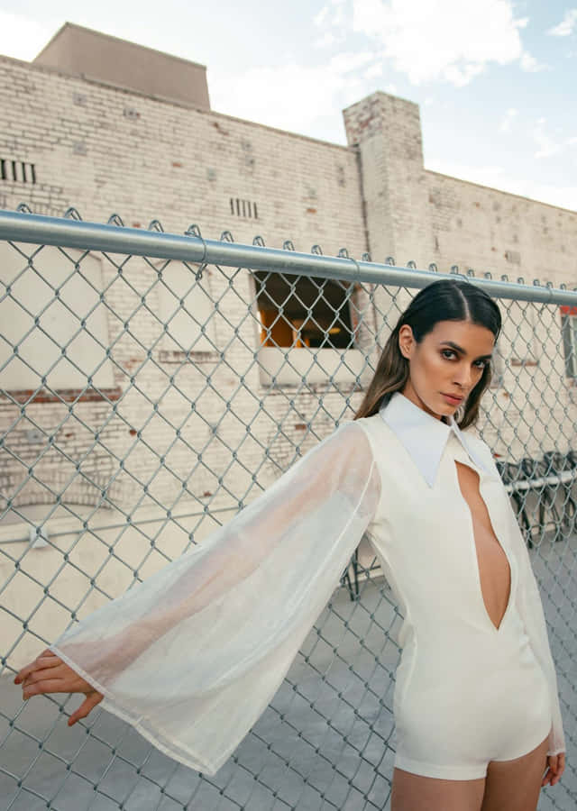 Fashion Model Chainlink Fence Urban Backdrop Wallpaper