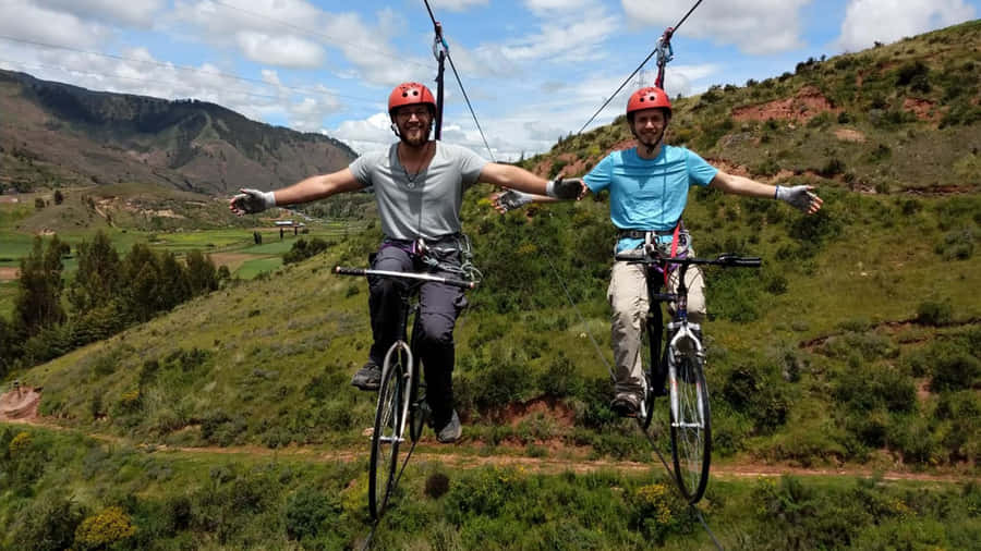 Fearless Adventurer Standing On A Cliff Edge Wallpaper