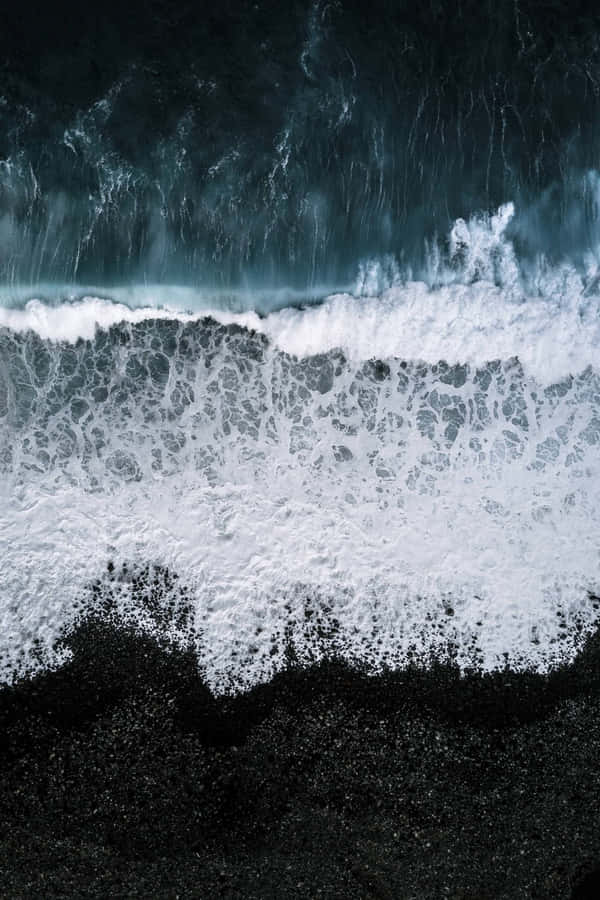 Feel The Warmth Of The Sun On Beautiful Black Sand Beach. Wallpaper