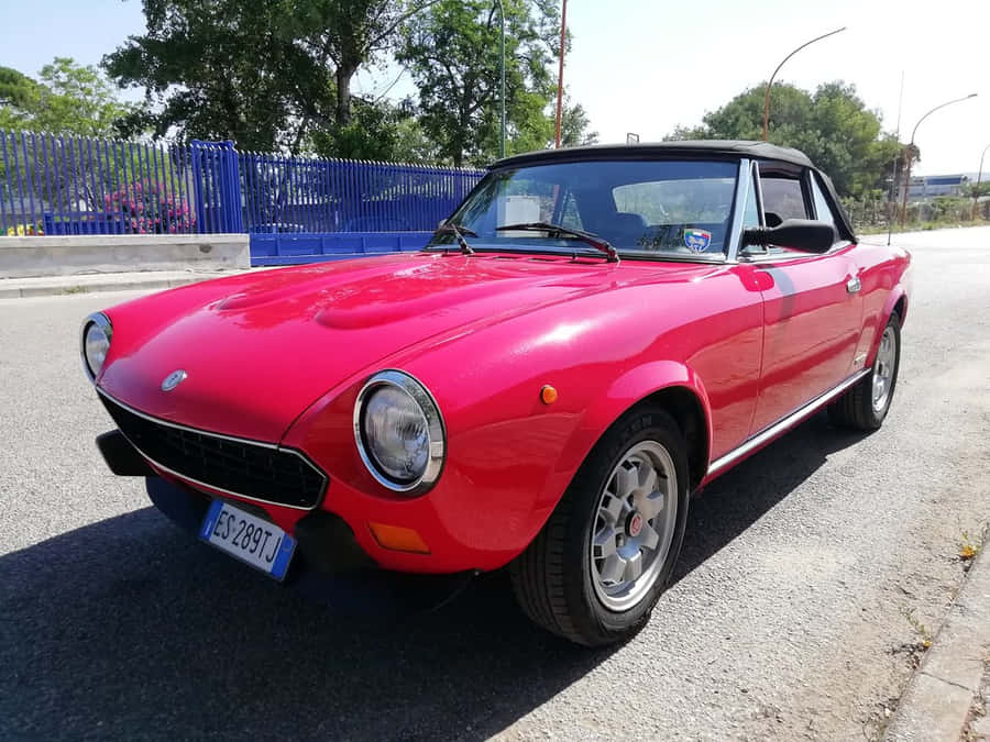 Fiat 124 Spider: Classic Elegance In Action Wallpaper