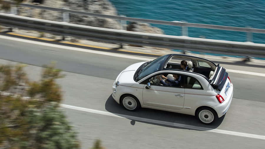 Fiat 500 In Vibrant Cityscape Wallpaper