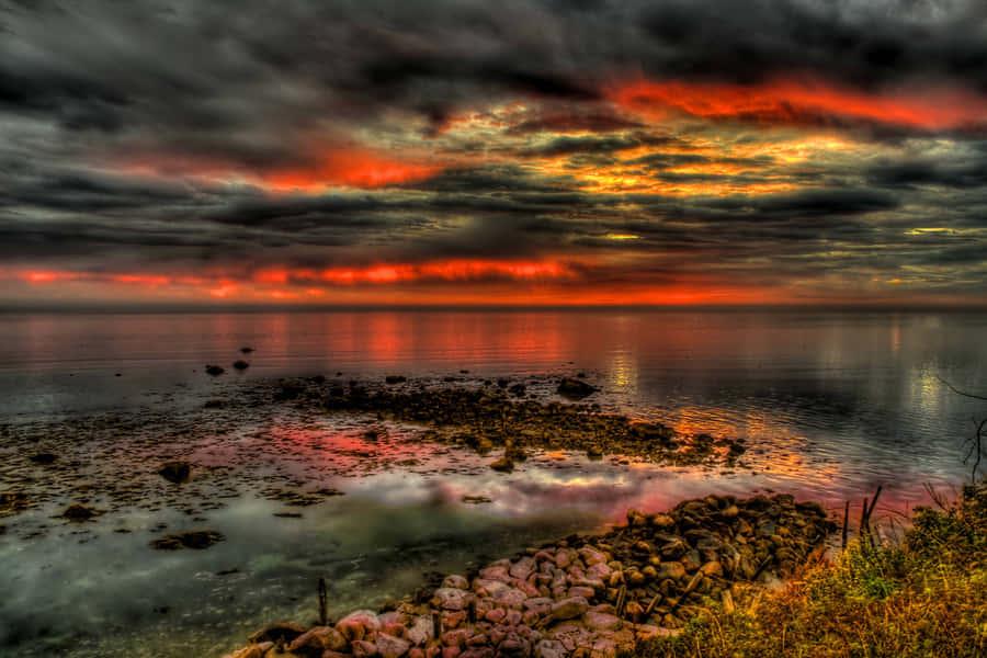 Fiery Sunset Over Calm Seas H D R Wallpaper