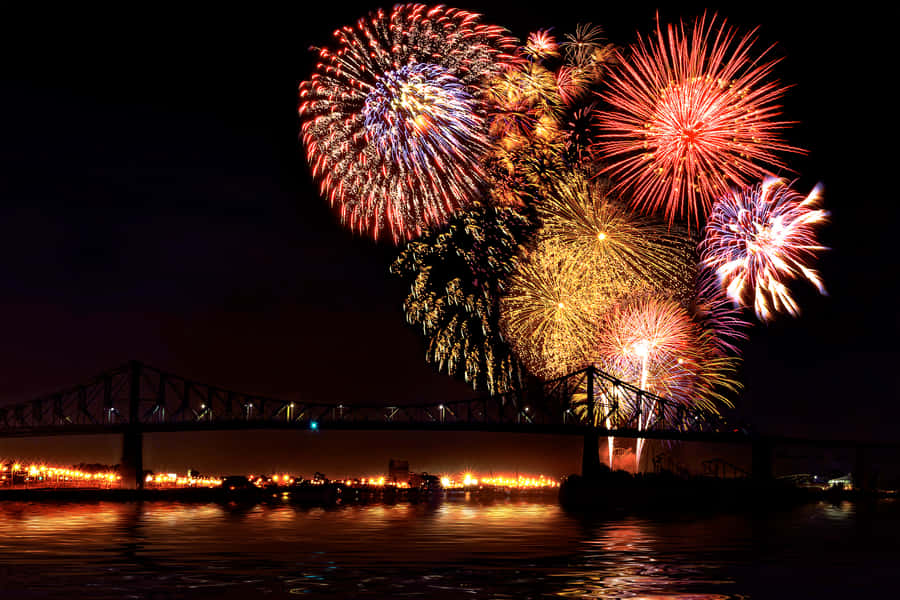 Fireworks Display Over Bridgeat Night Wallpaper