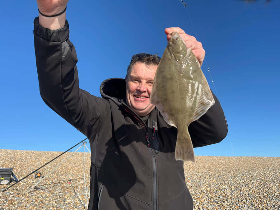 Fisherman Holding Caught Dab Fish Wallpaper