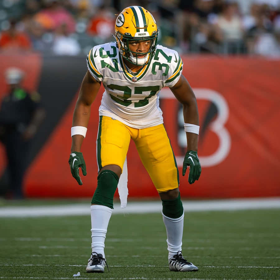 Focused Football Player Readyfor Action Wallpaper