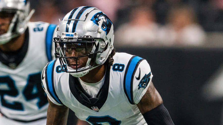 Focused Football Player Readyfor Action Wallpaper