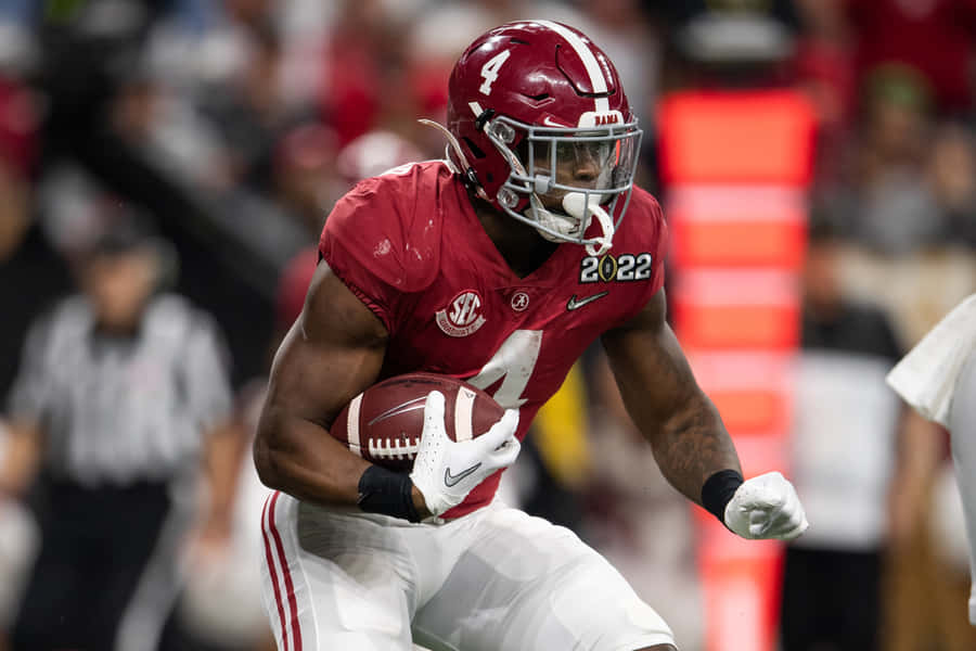 Focused Football Player Running Action Wallpaper