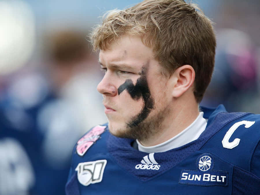 Focused Football Playerwith Eye Black Wallpaper