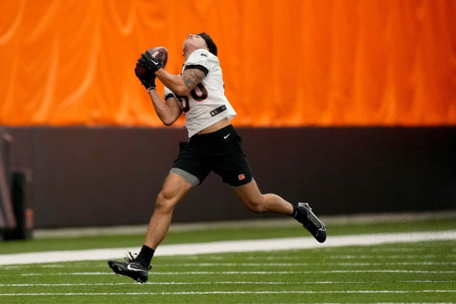 Football Catch In Action Wallpaper